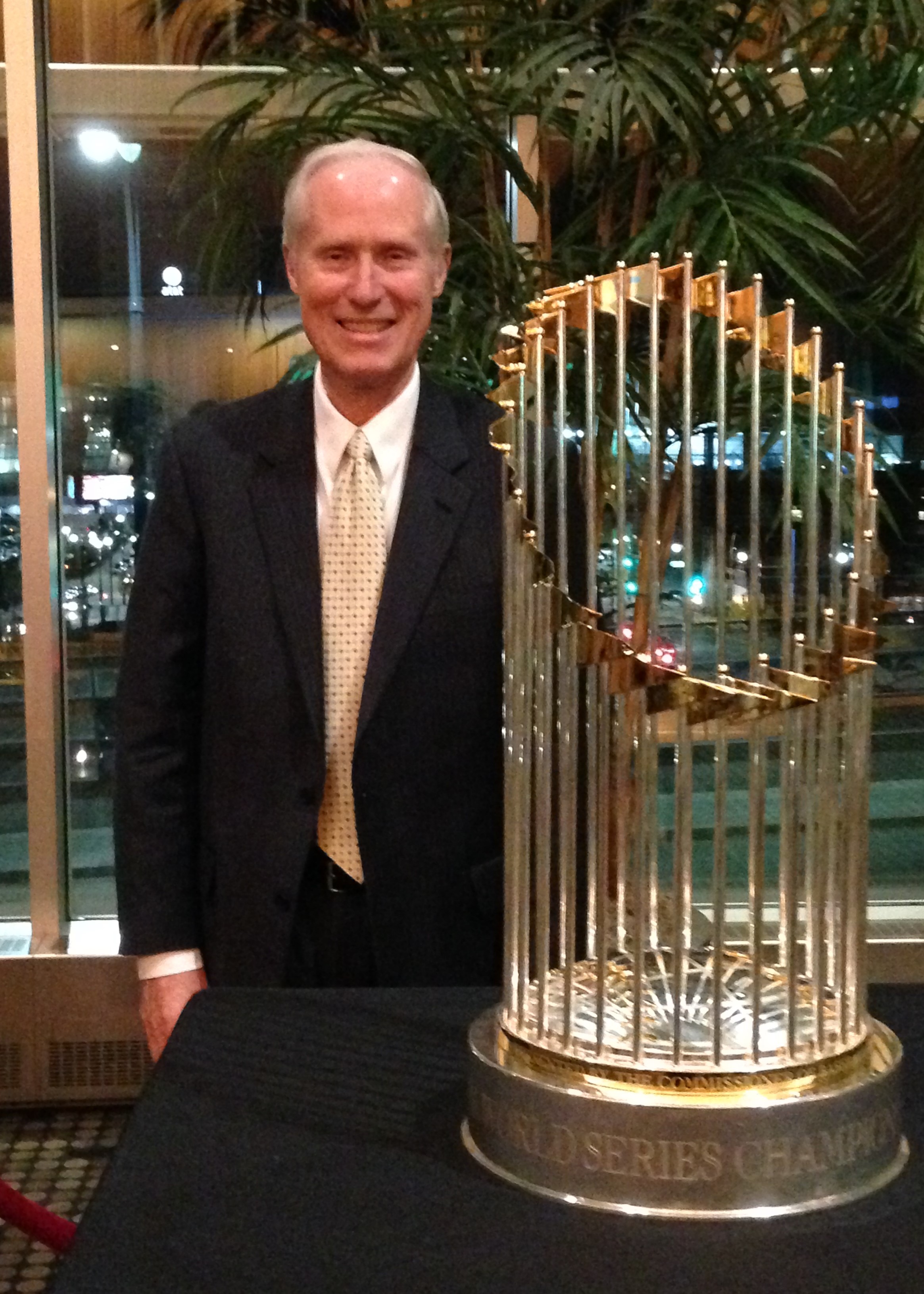 Larry standing next to the World Series Championship Trophy